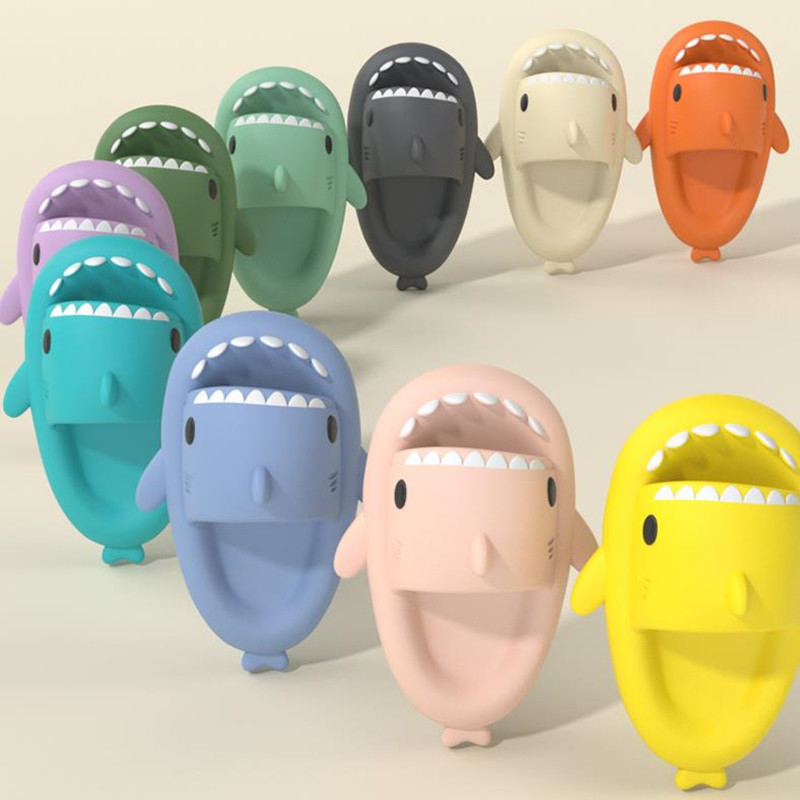Pink cartoon shark slides on feet
