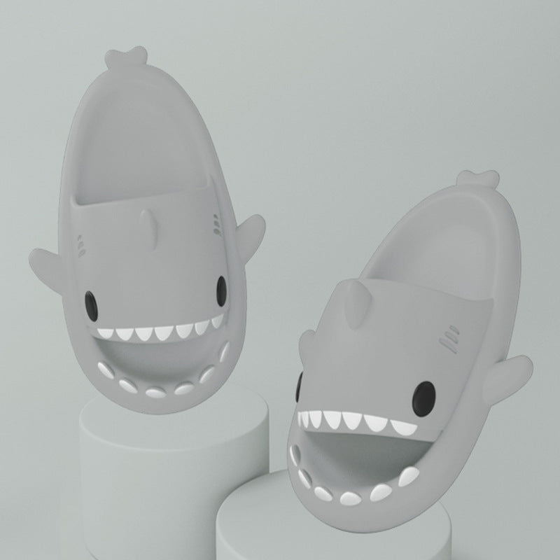 Pink cartoon shark slides on feet