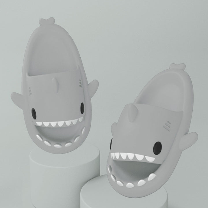 Pink cartoon shark slides on feet